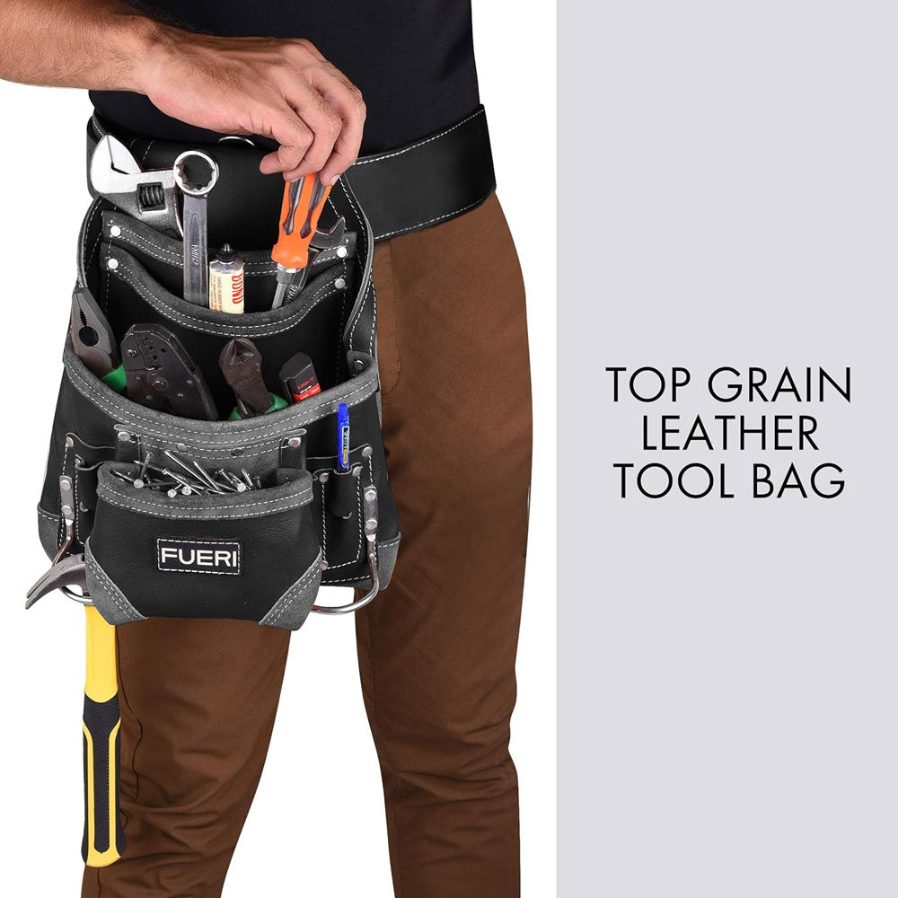 A close up view of a man's waist wearing FUERI LEATHER TOOL POUCH with leather work belt, 1 PENCIL POCKET, 2 FIXED HAMMER HOLDERS, displaying 4 LARGE POCKETS FOR ALL NECESSARY TOOLS